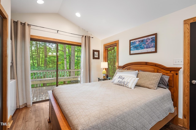 bedroom with vaulted ceiling, wood-type flooring, and access to outside