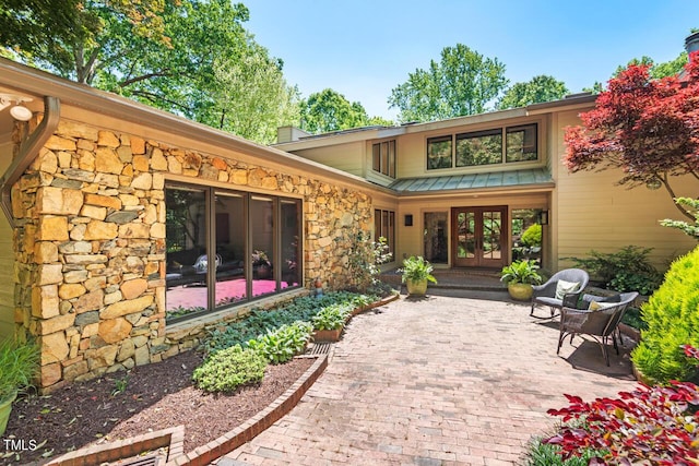 rear view of property with a patio area and french doors