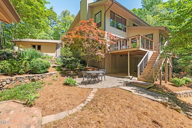 back of property with a patio and a wooden deck