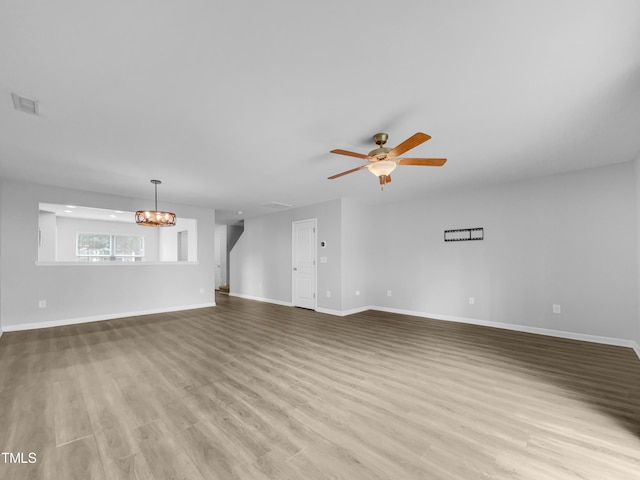 unfurnished living room featuring ceiling fan and light hardwood / wood-style floors