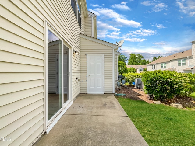 doorway to property featuring a yard and a patio