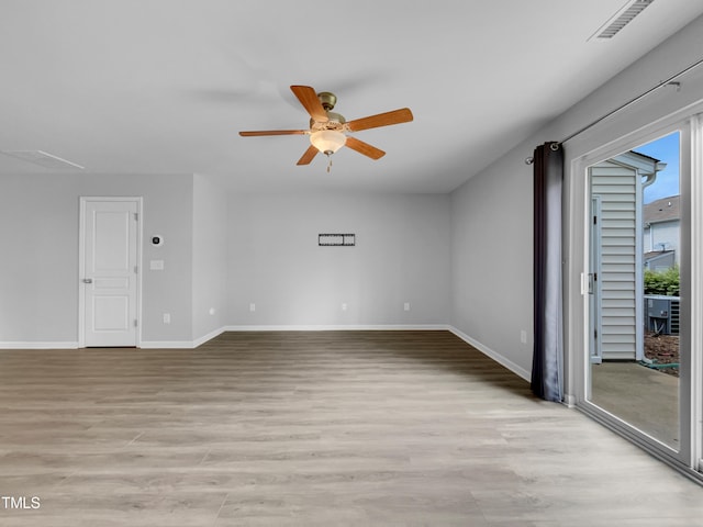 spare room featuring ceiling fan and light hardwood / wood-style flooring