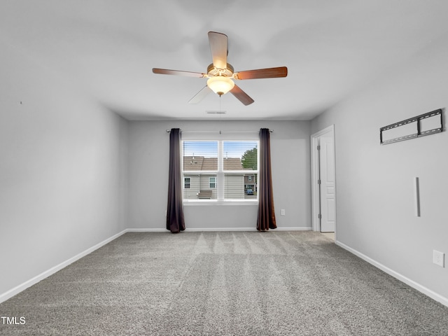 unfurnished room featuring ceiling fan and light colored carpet