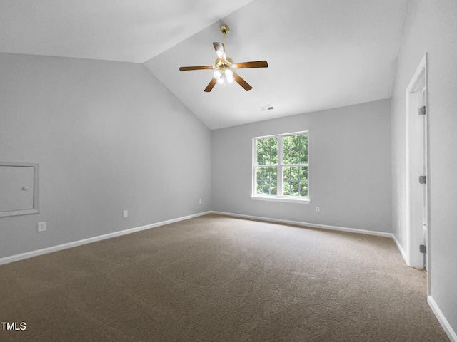 spare room featuring ceiling fan, carpet, and vaulted ceiling