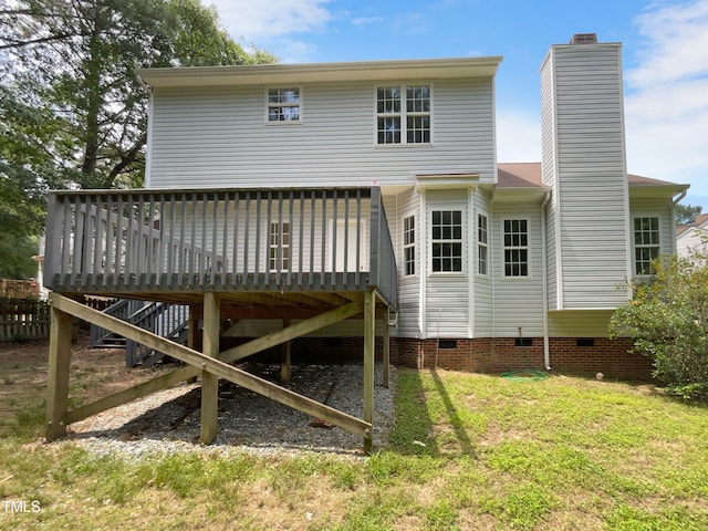 back of property featuring a yard and a wooden deck