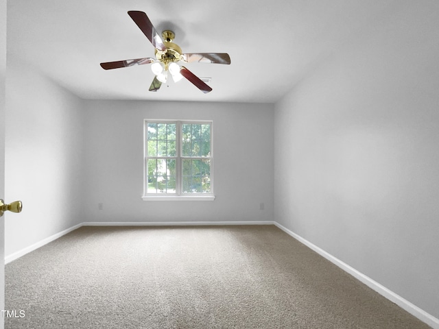 carpeted spare room with ceiling fan