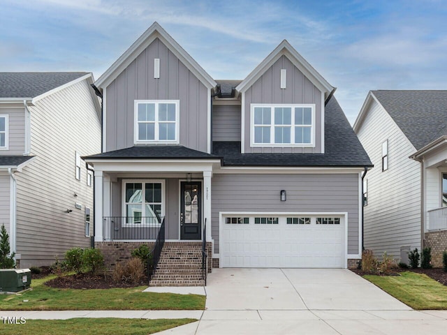 craftsman-style house featuring covered porch, central AC, and a garage