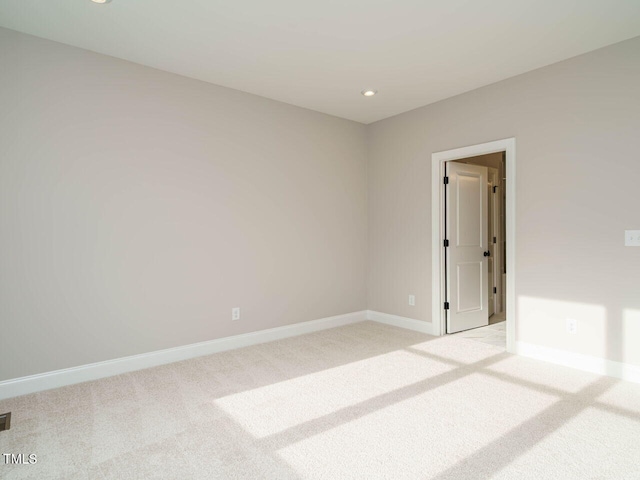 unfurnished room featuring light colored carpet