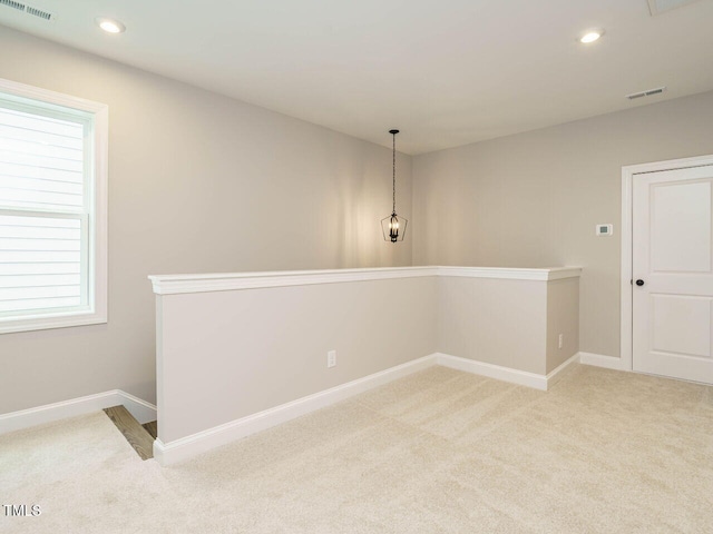 carpeted spare room with a healthy amount of sunlight