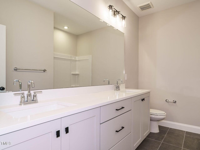 bathroom featuring tile patterned flooring, vanity, and toilet