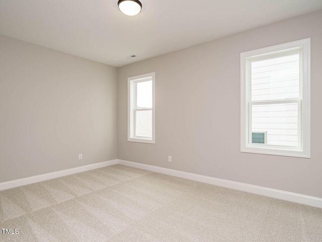 empty room featuring light colored carpet