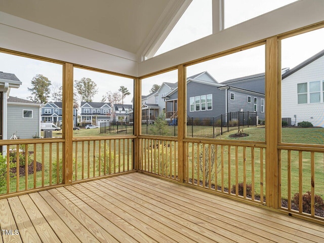 unfurnished sunroom featuring vaulted ceiling