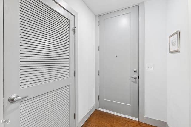 doorway with dark hardwood / wood-style flooring