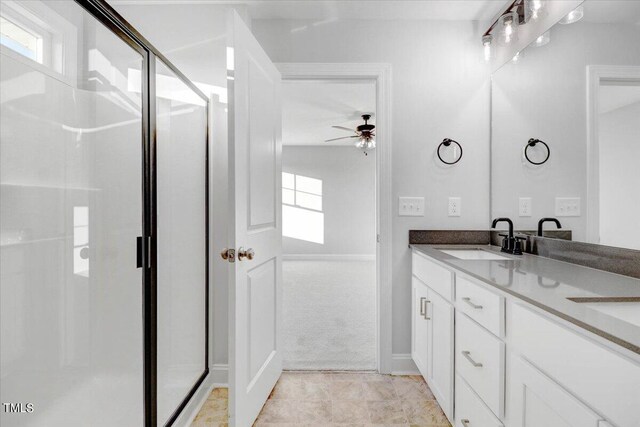 bathroom featuring plenty of natural light, an enclosed shower, and vanity