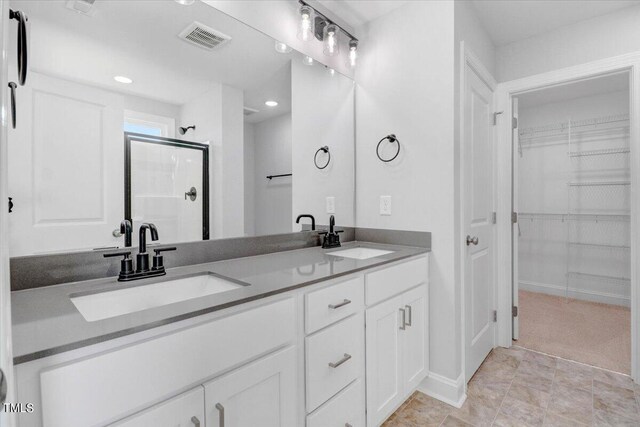 bathroom with walk in shower and vanity