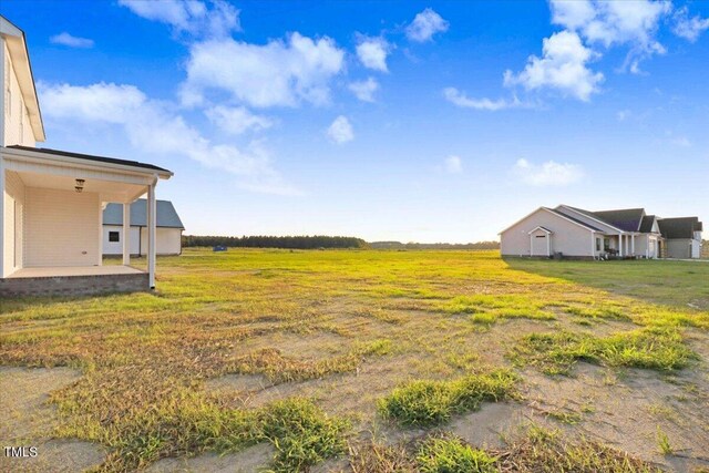 view of yard featuring a patio and a rural view