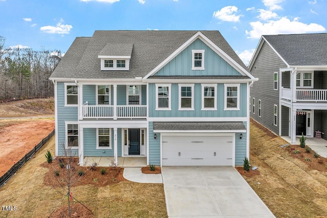 view of front of property with driveway, a shingled roof, board and batten siding, and an attached garage