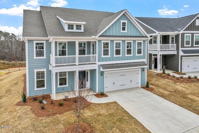 view of front of house featuring a shingled roof, board and batten siding, and concrete driveway