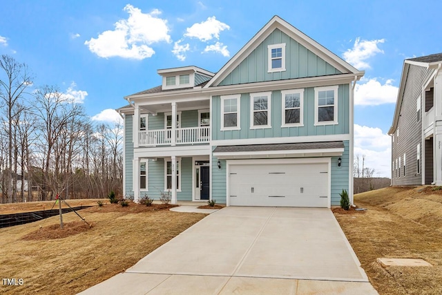 view of front of home with driveway, a garage, a shingled roof, covered porch, and board and batten siding