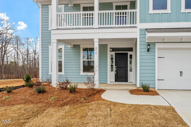 entrance to property with a garage, a porch, board and batten siding, and a balcony