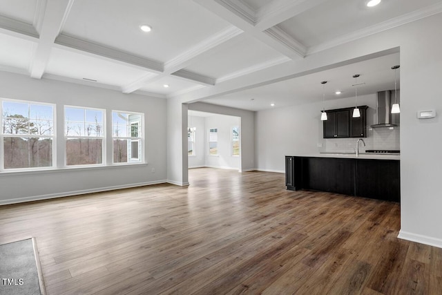 unfurnished living room with baseboards, coffered ceiling, wood finished floors, and beamed ceiling