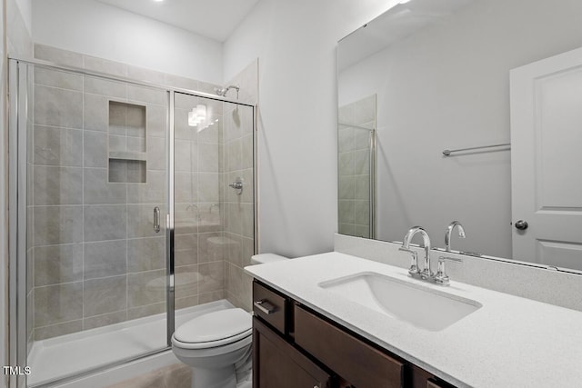 full bath featuring a shower stall, toilet, and vanity