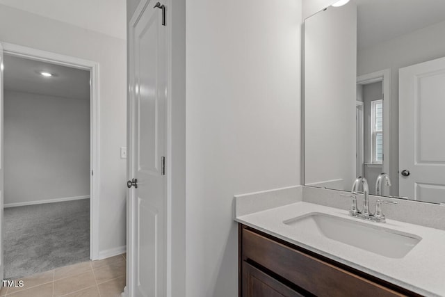 bathroom featuring tile patterned flooring, baseboards, and vanity