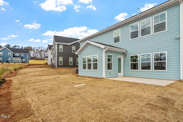 back of property featuring a patio area and a yard