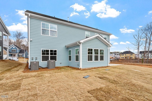 rear view of house featuring a yard and cooling unit