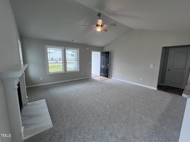 unfurnished living room with carpet flooring, a fireplace with flush hearth, visible vents, lofted ceiling, and ceiling fan