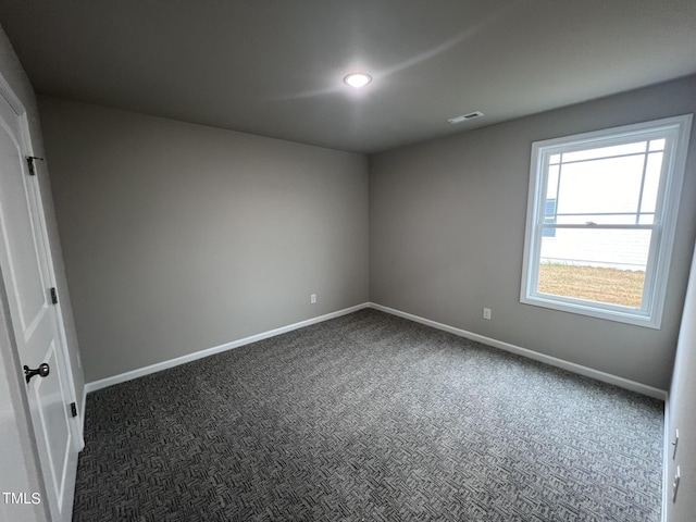 empty room featuring recessed lighting, visible vents, baseboards, and dark carpet