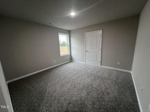 carpeted spare room with baseboards