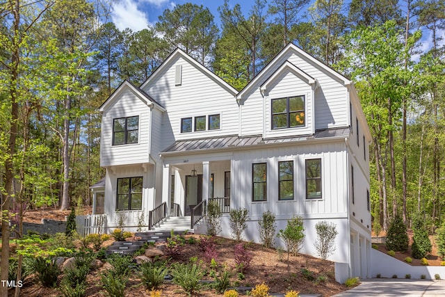 modern farmhouse style home featuring covered porch and a garage