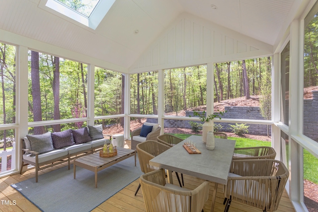 sunroom with vaulted ceiling with skylight