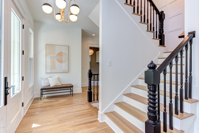 entryway featuring an inviting chandelier and light hardwood / wood-style floors