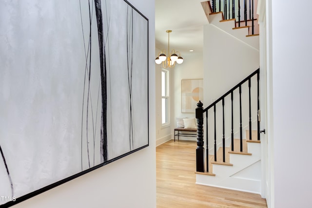 entrance foyer with a chandelier and hardwood / wood-style flooring