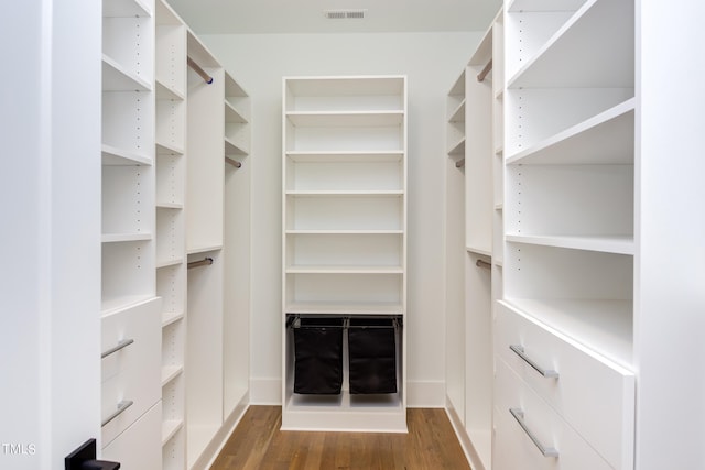 walk in closet featuring dark wood-type flooring