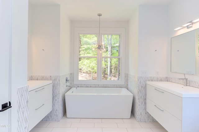 bathroom with tile walls, vanity, and tile patterned flooring