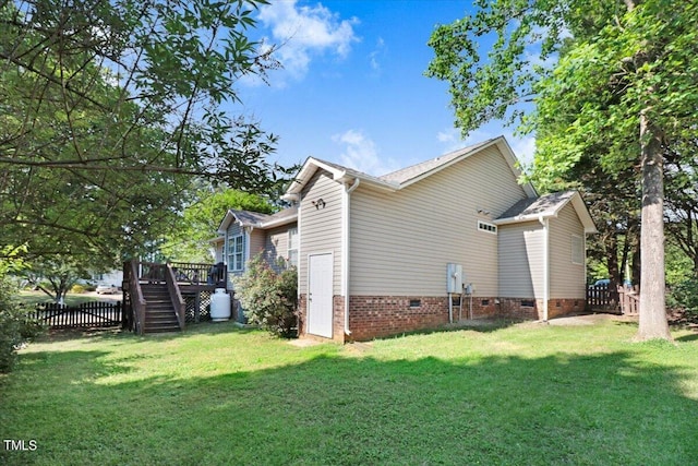 view of property exterior featuring a deck and a lawn