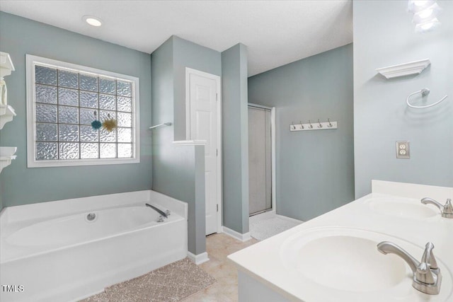 bathroom with vanity and independent shower and bath