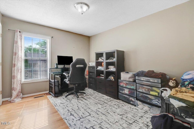 office area featuring hardwood / wood-style floors and a textured ceiling