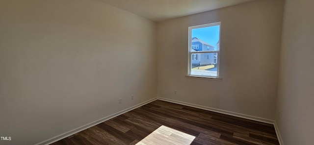 unfurnished room with dark hardwood / wood-style flooring and a wealth of natural light