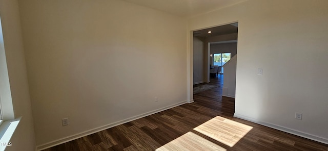 unfurnished room featuring dark hardwood / wood-style flooring