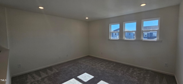 empty room featuring dark carpet