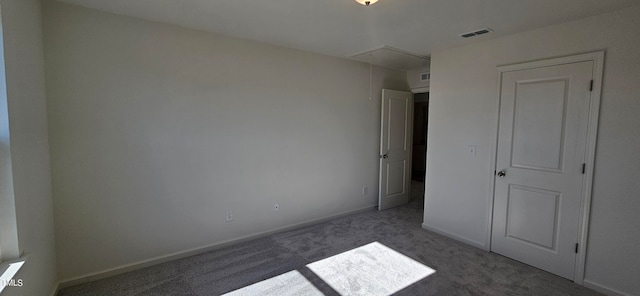 unfurnished bedroom with dark carpet