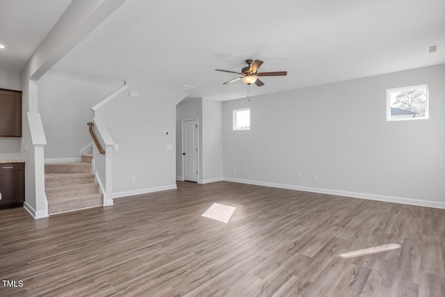 unfurnished living room with ceiling fan and light wood-type flooring