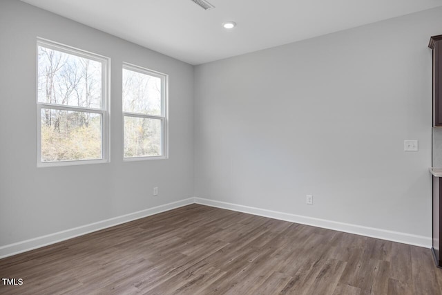 unfurnished room featuring dark hardwood / wood-style floors