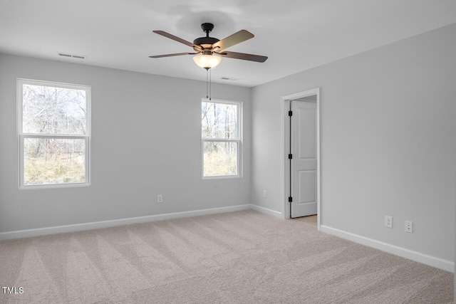 carpeted empty room featuring ceiling fan