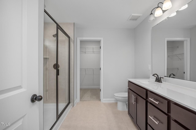 bathroom featuring walk in shower, tile patterned floors, vanity, and toilet