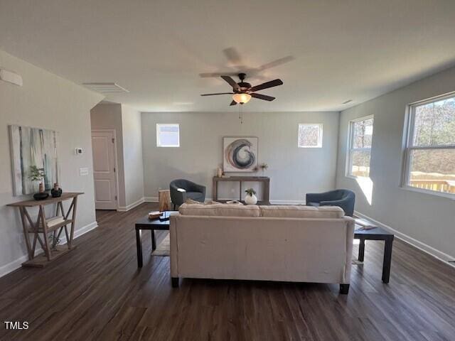 living room featuring ceiling fan and dark hardwood / wood-style flooring